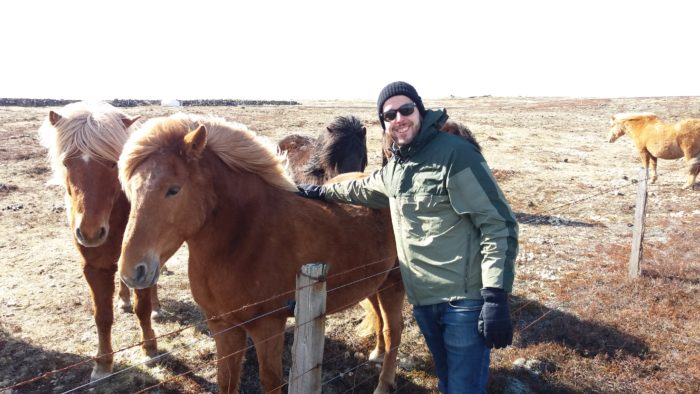 a man smiling with Icelandic horses