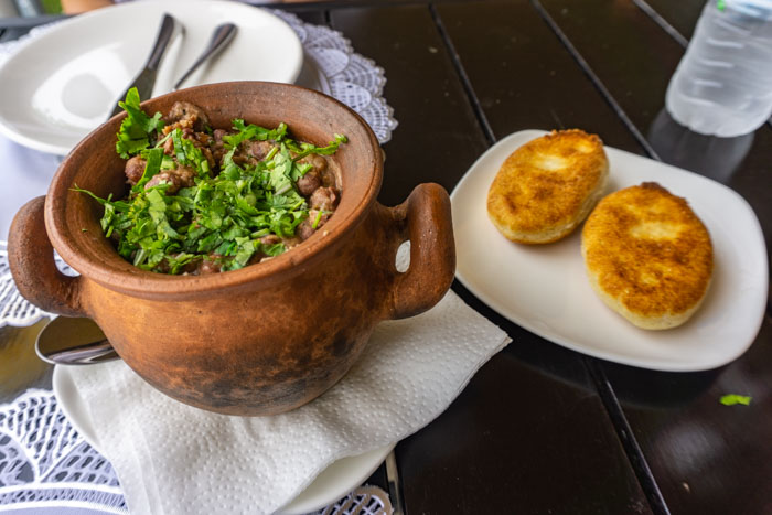 Lobio served in a traditional pot with cornbread