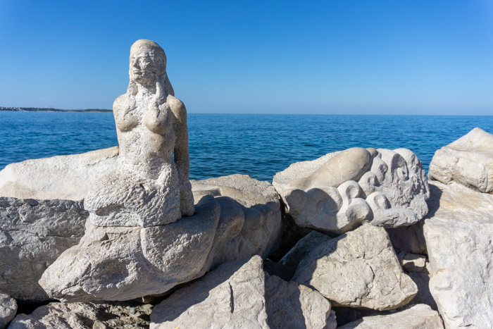 Mermaid sculpture carved into the rocks
