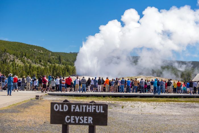 Tourists watching the Old Faithful Geyser
